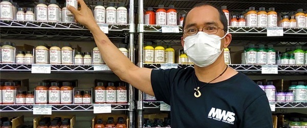 Mel behind the counter at MWS Meet Our MWS Staff